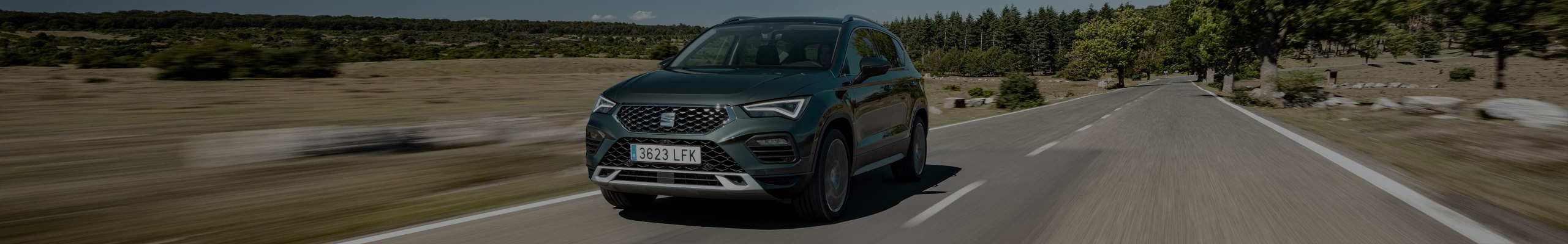 grey SEAT Ateca driving on country road