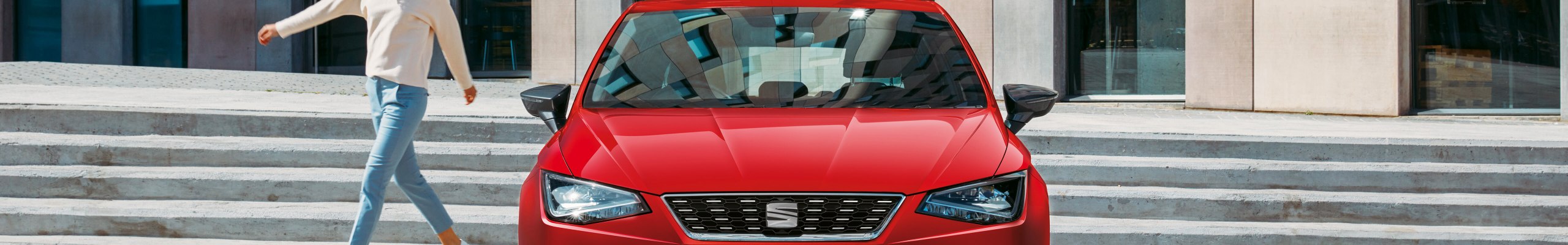 front view red SEAT Ibiza parked in the city