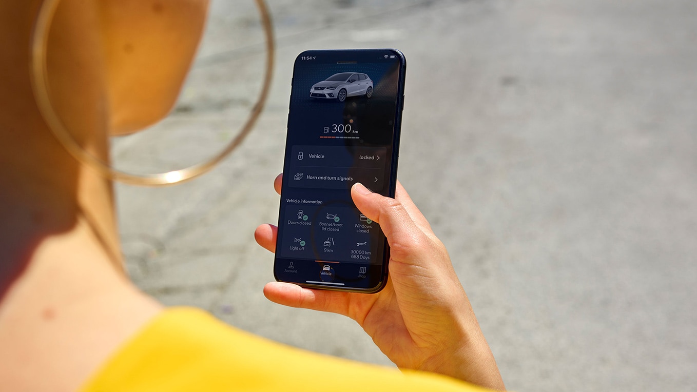 A person holding their smartphone with the SEAT Connect app on the screen
