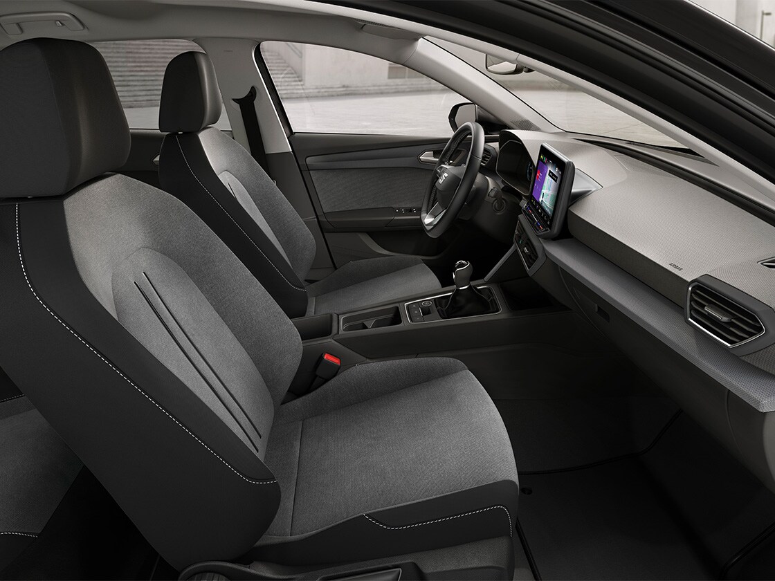 Interior view of SEAT Leon featuring cloth comfort seats, offering a relaxed and practical driving. experience.
