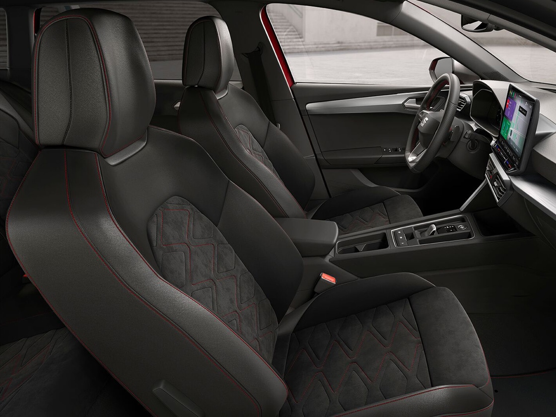 Interior view of SEAT Leon Estate FR Black Edition featuring Soul Black Microsuede with Lava Red stitching, combining ergonomic support and stylish design for a comfortable journey.