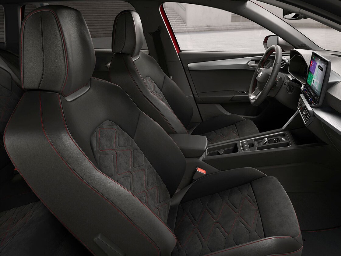 Interior view of SEAT Leon Estate FR Sport featuring Soul Black Microsuede with Lava Red stitching, combining ergonomic support and stylish design for a comfortable journey.