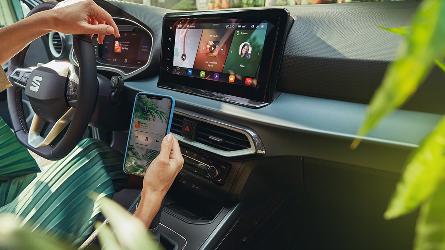 A woman looking at her smartphone inside of a SEAT Arona