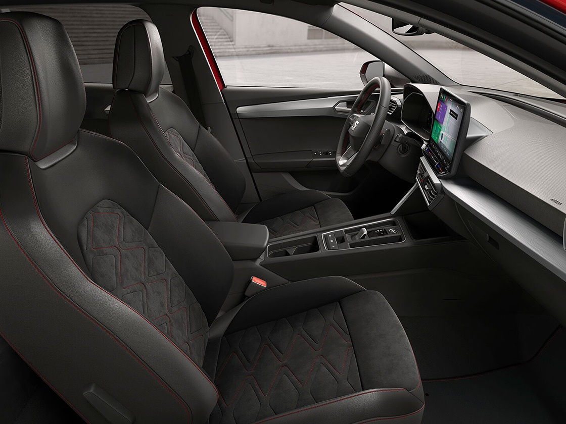 Interior view of SEAT Leon Estate FR Sport featuring soul black microsuede with lava red stitching and stylish design for a comfortable journey.