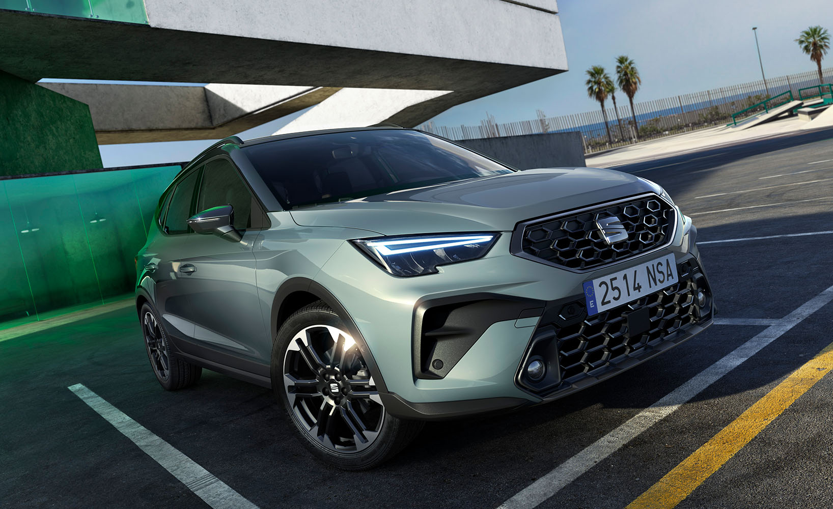 A close-up frontal shot of a new green SEAT Arona