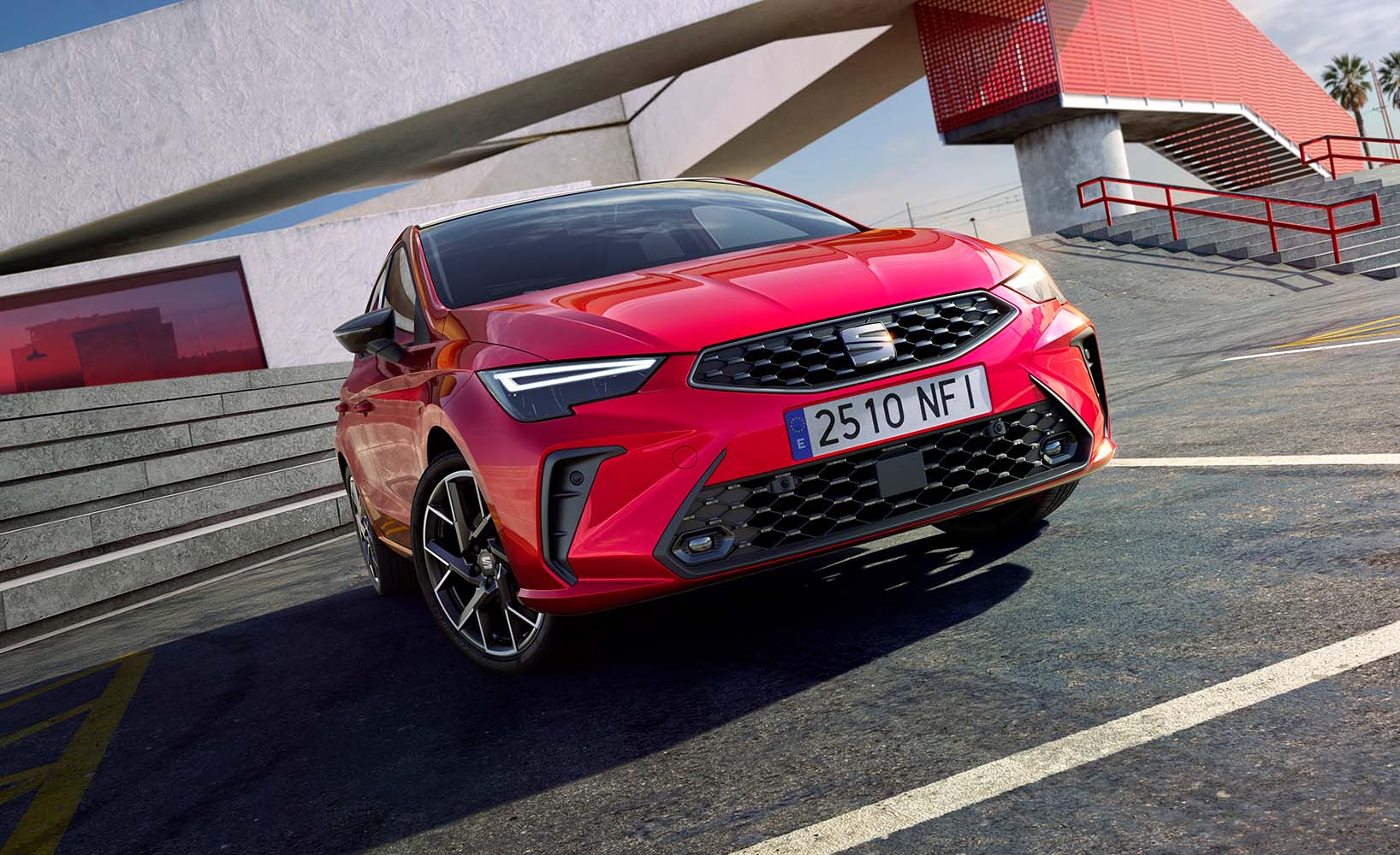 A close-up frontal shot of a new red SEAT Ibiza