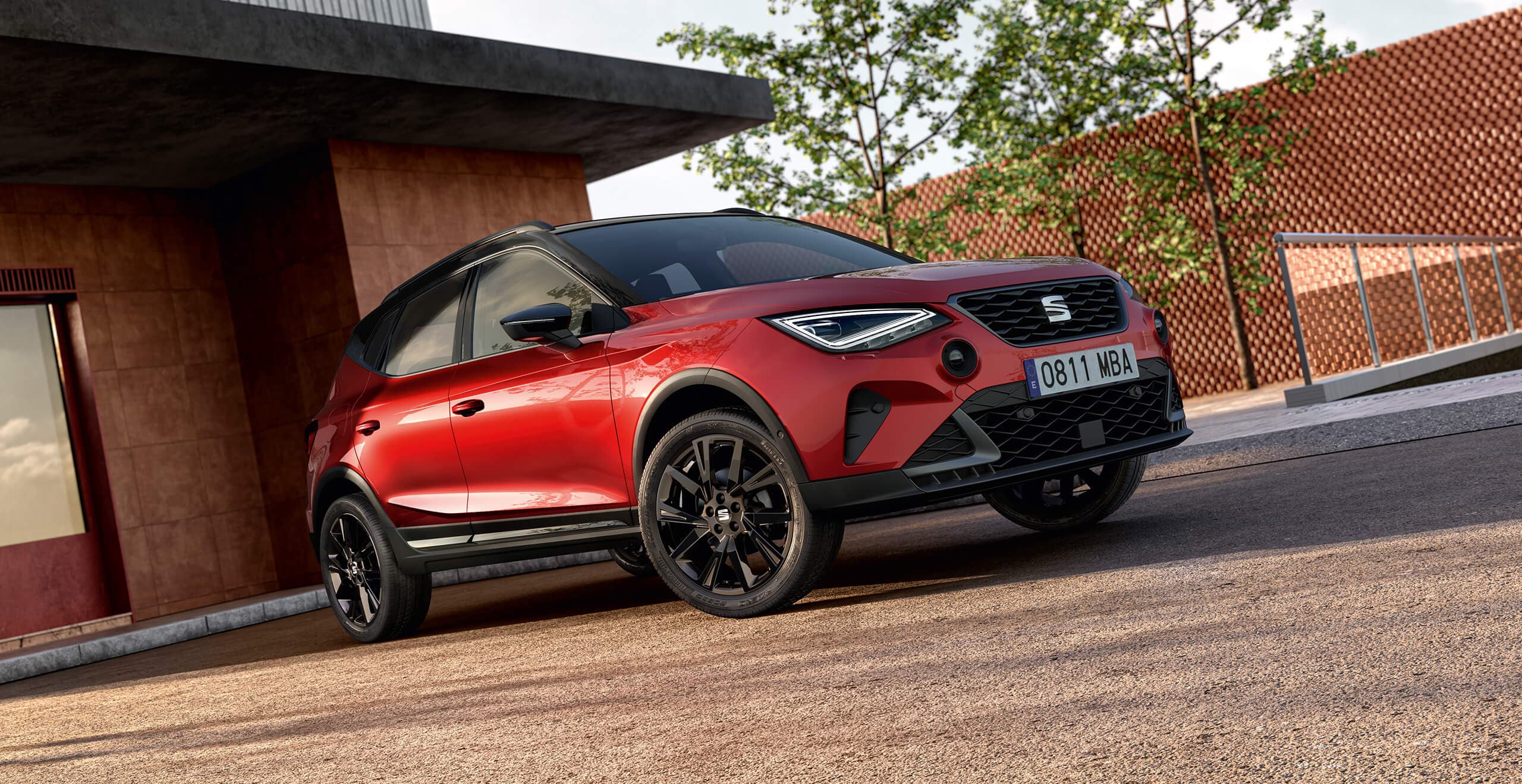 A red SEAT Arona FR Black Edition on a gravellled parking space