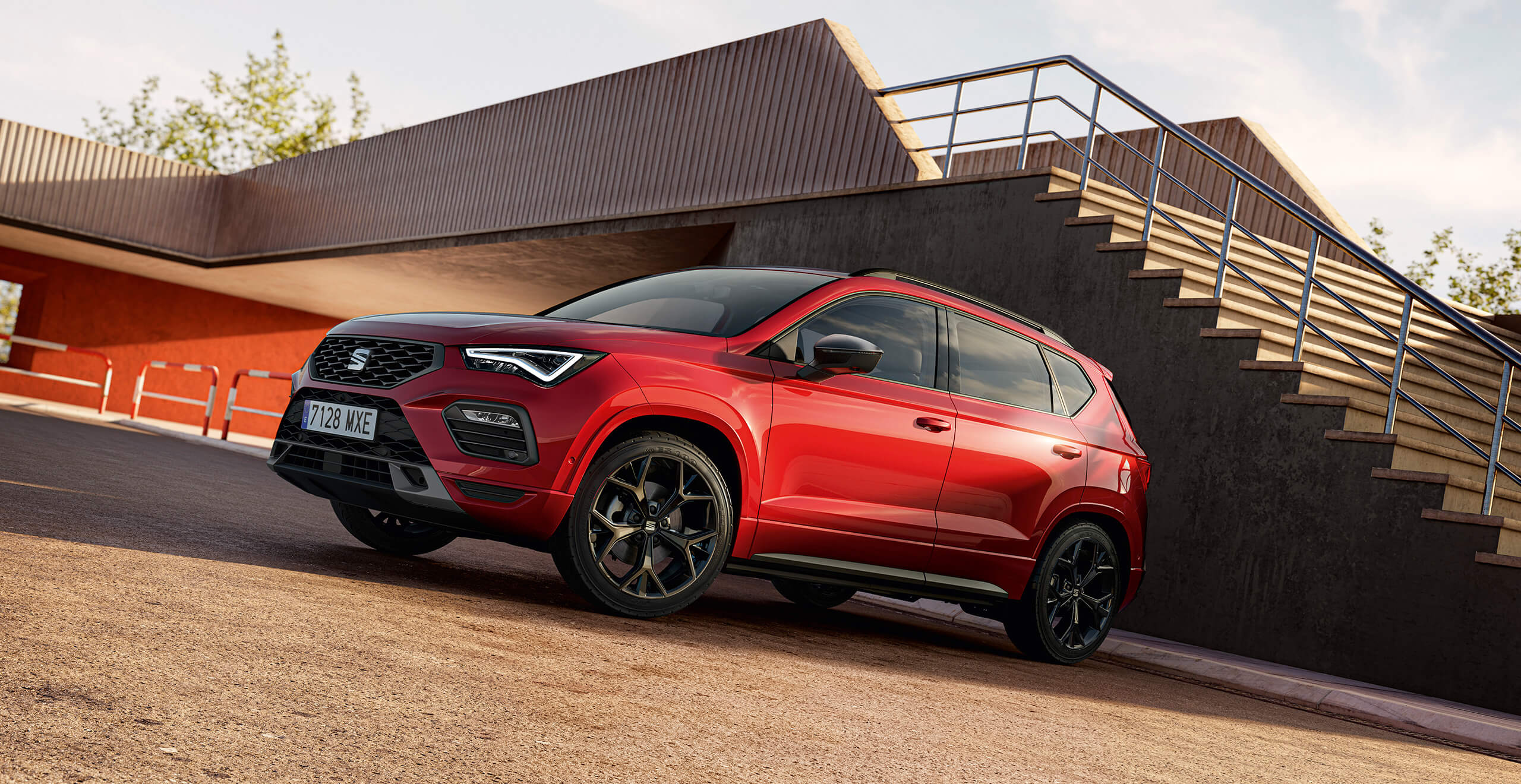 A red SEAT Ateca on a gravelled car park