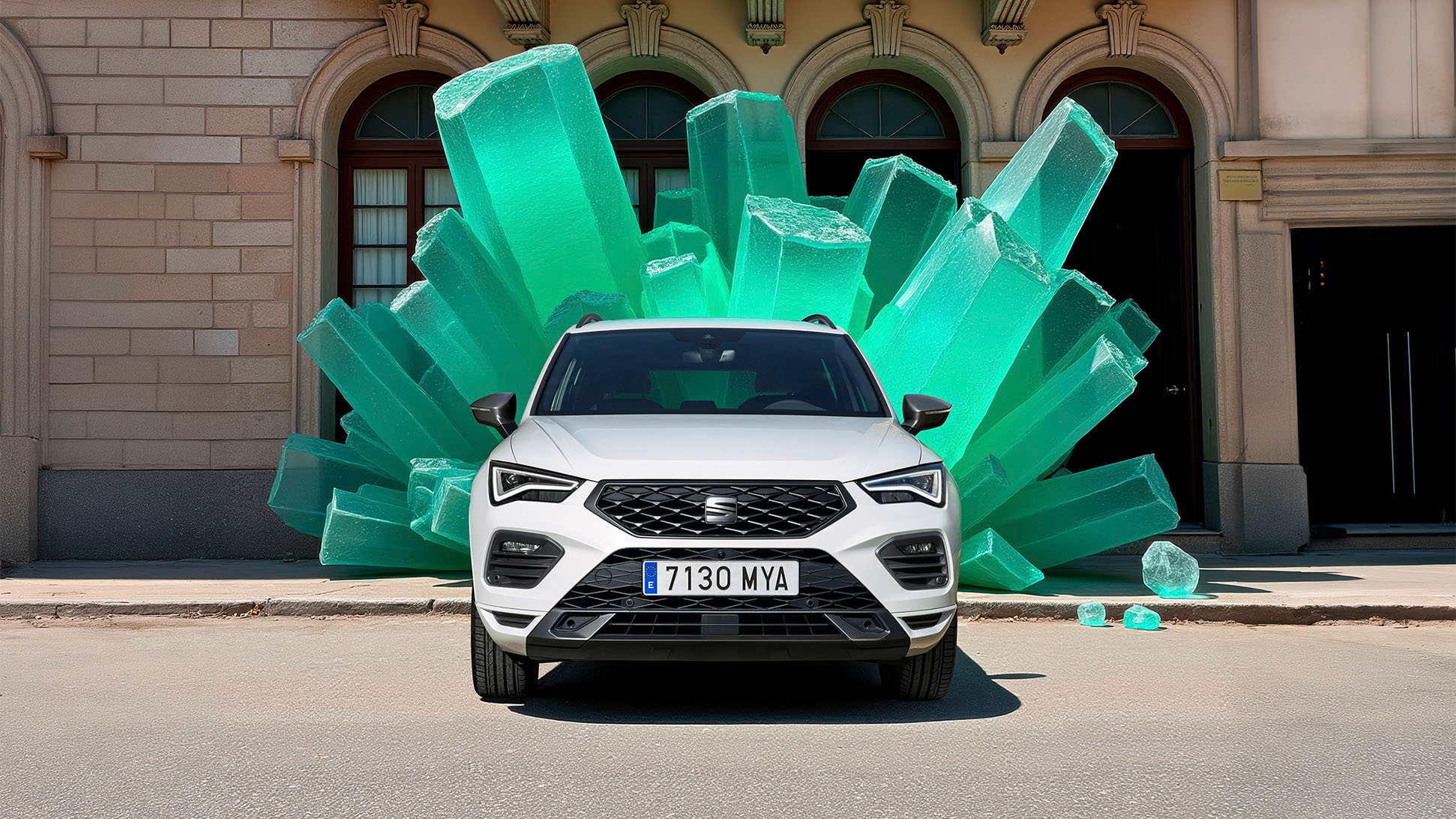 A front view of a white SEAT Ateca, in front of a large green gemstone