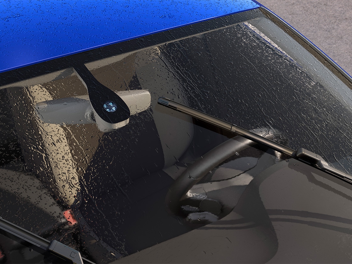 Wet windscreen with wipers on, being activated by the rain and light sensor