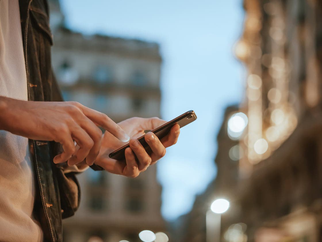 A close up of a pair of hands holding a smartphone