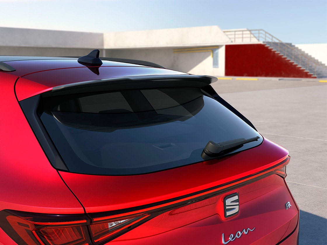 Red SEAT Leon with a sporty roof spoiler, enhancing aerodynamic flow and performance for the entry-level or advanced trims.