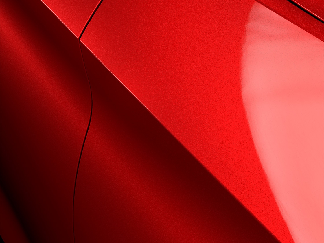 The Leon Estate car in Desire Red with a metallic finish, close up.