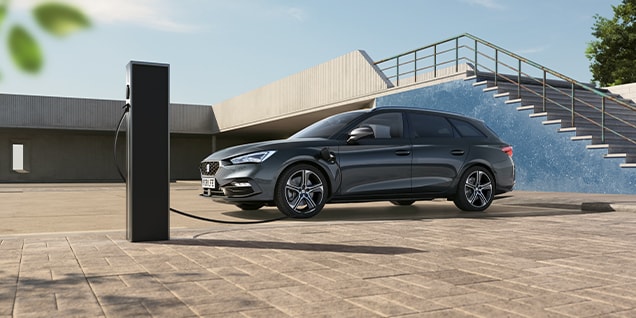 seat leon phev at a public charging station, emphasising expanded access to charging networks for hybrid car users.