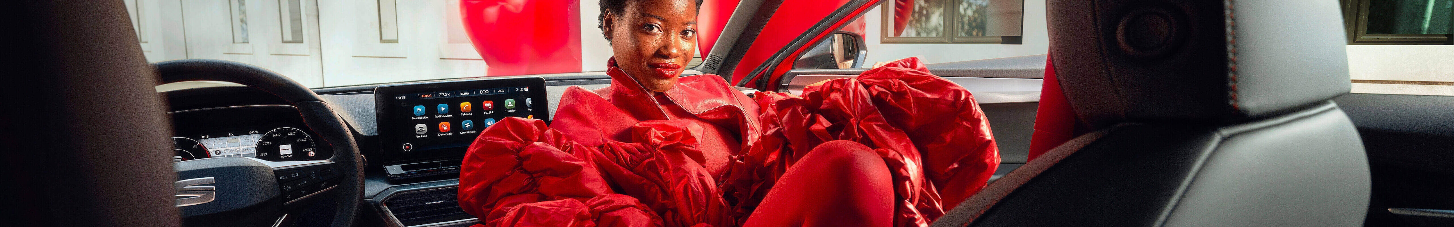 Plug in hybrid electric vehicle seat leon in red, rear view lights, sunset and sea