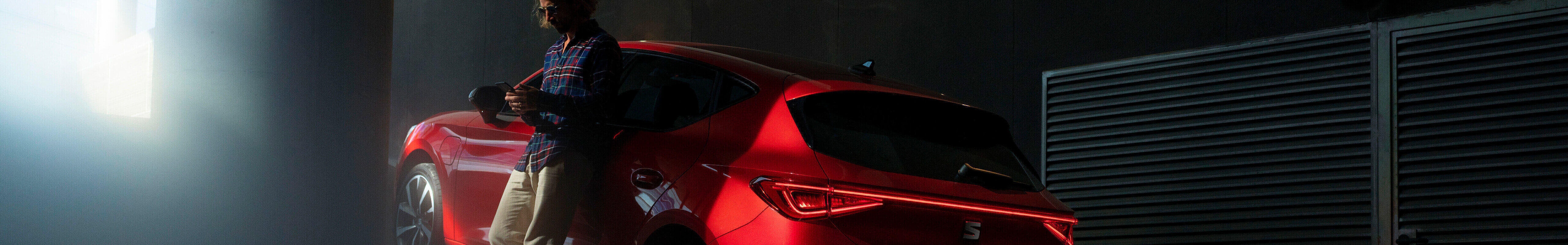 Hybrid car seat leon sportstourer in blue on the road, driver opening car door in the city, shadows