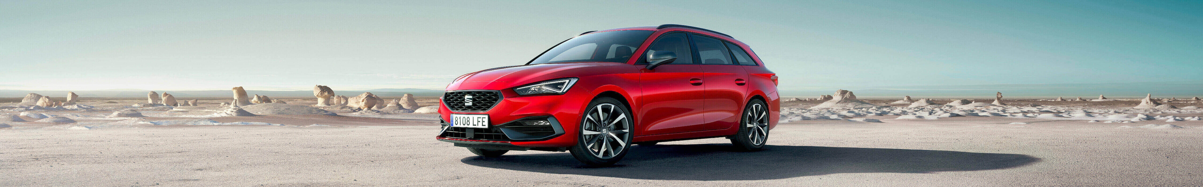 Seat ateca, one of seat’s end of life vehicles (elvs) parked outside wooden building by two models. 