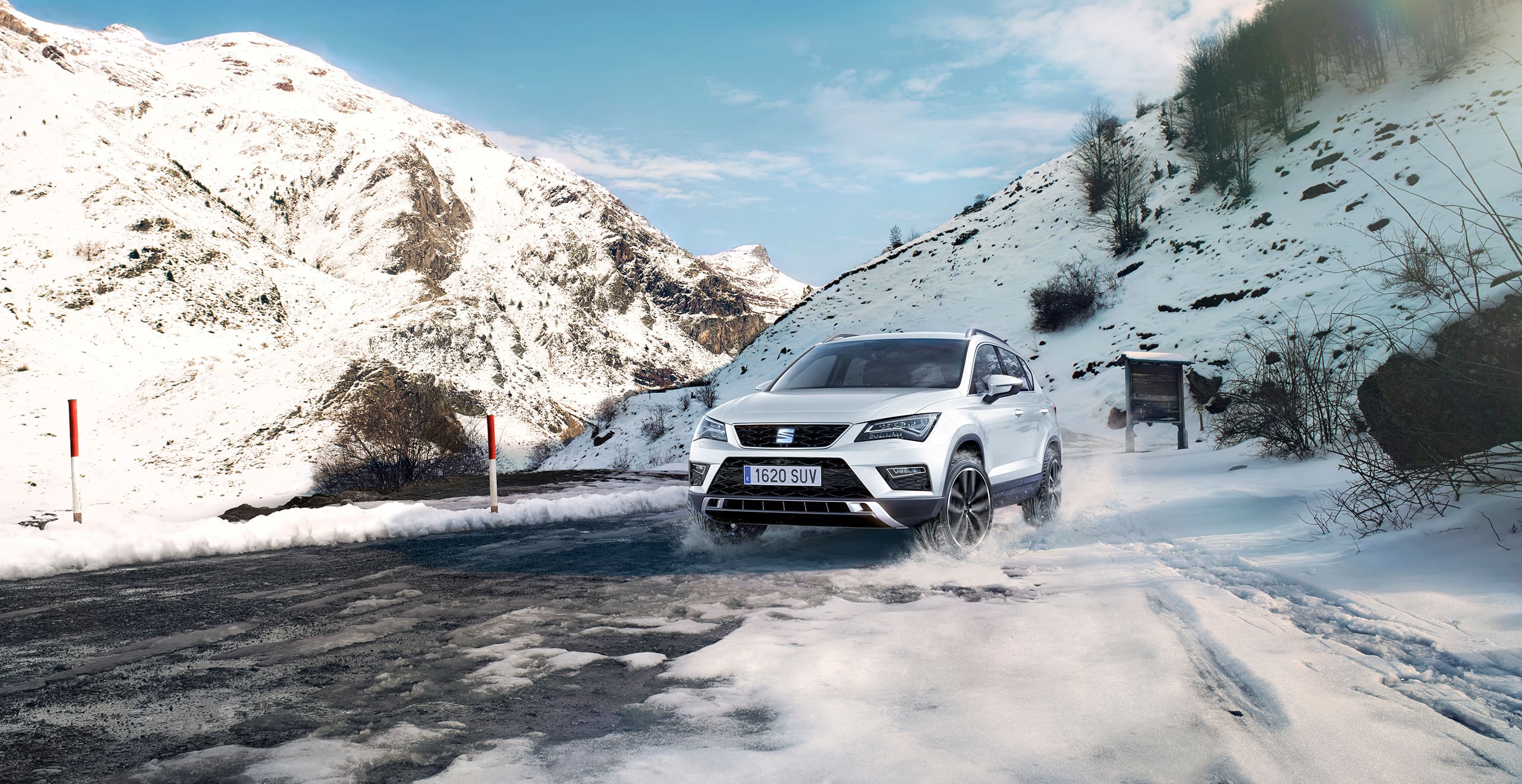 Exterior front action shot of a SEAT Ateca SUV in snowy mountains